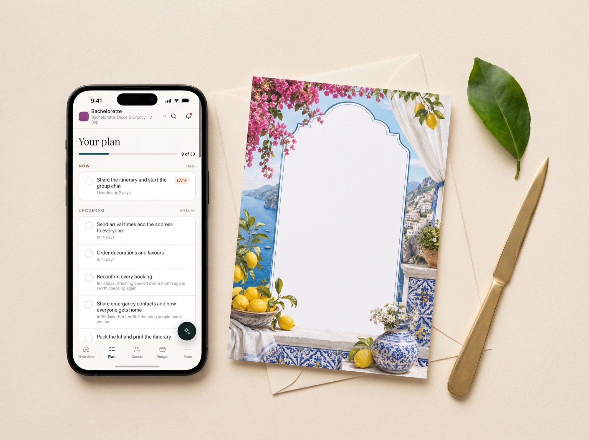 A phone showing the plan beside a printed lemon-bordered invitation and its envelope